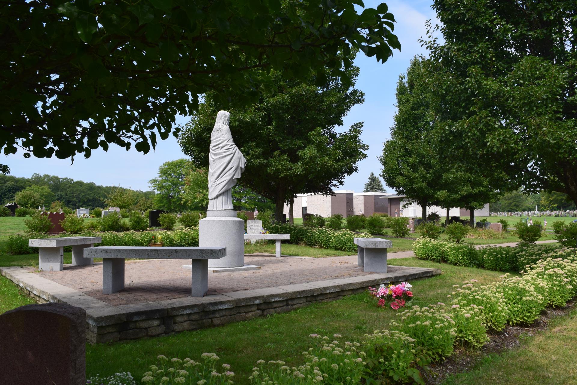 Reflection benches surround a monument at St. Peter's Cemetery